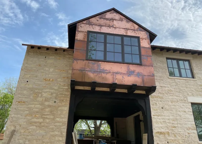 Copper metal panel facade on a stone building for Skylight Installation in Eatonton